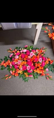 Sympathy Bright Casket Spray — Sympathy floral arrangement by Long's Florist